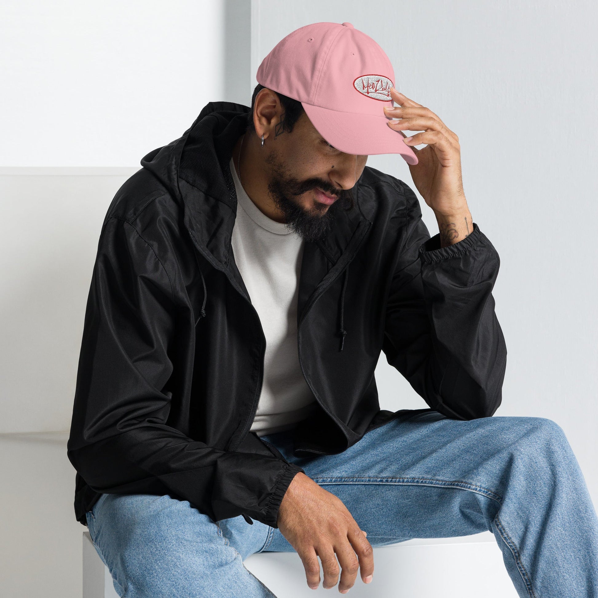 Chill vibes with a side of style. Meet our guy rocking the MeaKulpa Pink Hat, featuring the iconic OG Logo. Sitting comfortably, he effortlessly brings together urban coolness and a laid-back demeanor. Elevate your look, make a statement. 