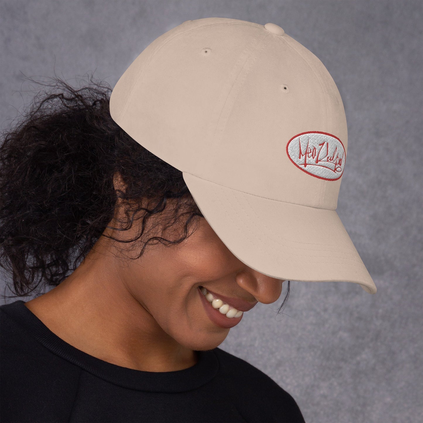 Embrace the subtlety of style with the MeaKulpa Stone-Colored Hat, worn by a smiling girl casting a mysterious gaze downward. This neutral tone exudes sophistication, while her playful smile hints at the urban coolness within. Elevate your look, create intrigue.