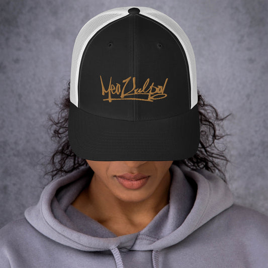 Front View of MeaKulpa Trucker Cap with Gold Logo - Step into classic elegance with our MeaKulpa Trucker Cap. The gold MeaKulpa logo takes center stage on the black front, creating a bold statement against the timeless white mesh back. This cap is more than an accessory; it's a symbol of style and authenticity.