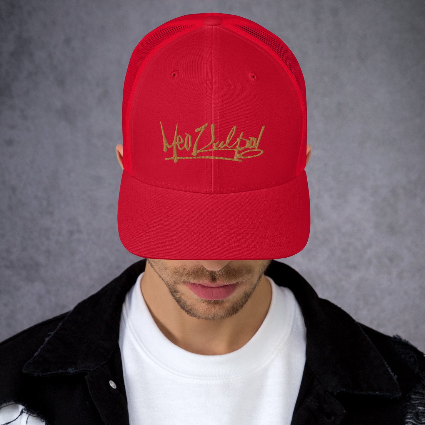 Close-up Detail of Gold MeaKulpa Logo on Red Trucker Cap Zoom in on luxury with a close-up of the MeaKulpa Red Trucker Cap. The intricate gold MeaKulpa logo stands out against the bold red, showcasing the meticulous craftsmanship that defines this signature accessory.
