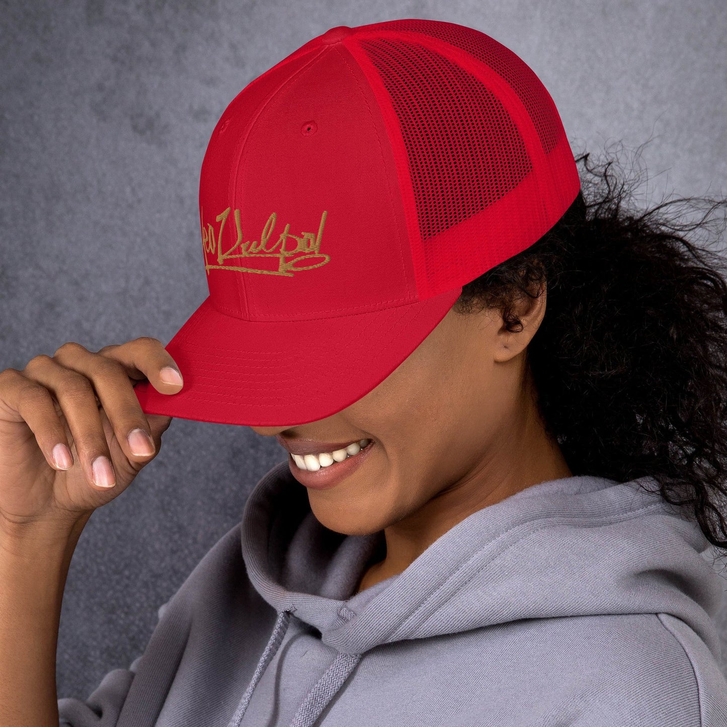  MeaKulpa Red Trucker Cap in the Action Experience the MeaKulpa lifestyle in the great outdoors. This lifestyle shot captures the Red Trucker Cap in action, blending seamlessly with nature. The gold logo adds a touch of opulence to your everyday adventures.