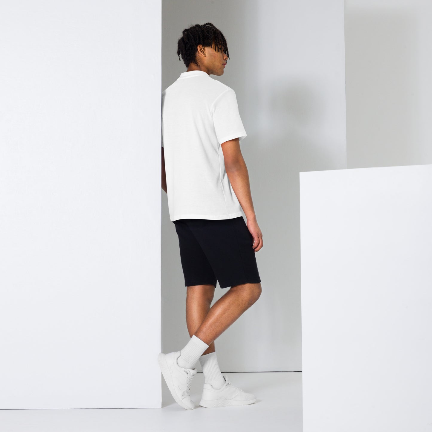 Embrace effortless elegance with the MeaKulpa Unisex Pique Polo Shirt in White. Made from high-quality ring-spun cotton, this shirt combines comfort with timeless style. Its semi-fitted silhouette and classic collar make it a versatile addition to any wardrobe. Dress it up with chinos for a smart-casual look or pair it with jeans for a relaxed weekend vibe. The perfect choice for understated sophistication. Boy side shot and back shot photo