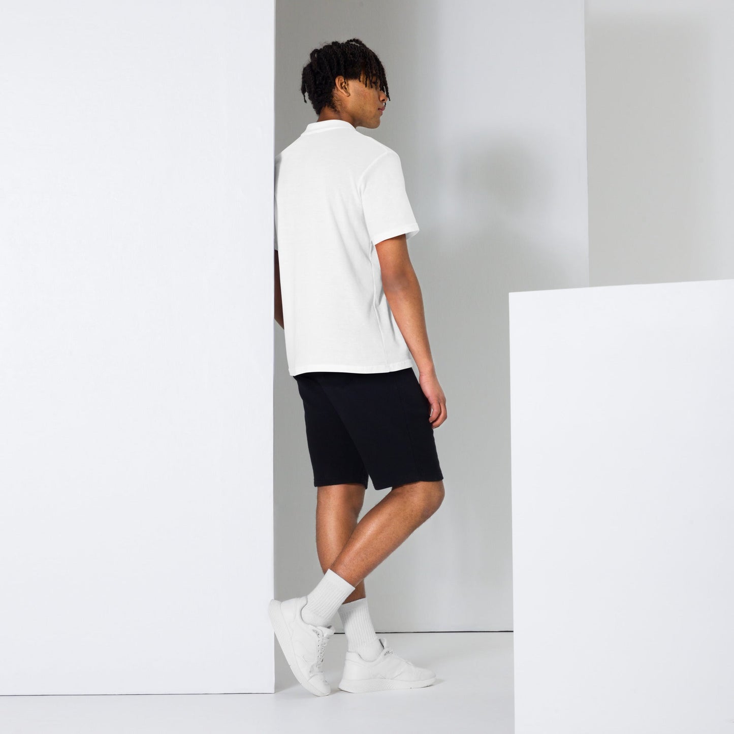 Embrace effortless elegance with the MeaKulpa Unisex Pique Polo Shirt in White. Made from high-quality ring-spun cotton, this shirt combines comfort with timeless style. Its semi-fitted silhouette and classic collar make it a versatile addition to any wardrobe. Dress it up with chinos for a smart-casual look or pair it with jeans for a relaxed weekend vibe. The perfect choice for understated sophistication. Boy side shot and back shot photo